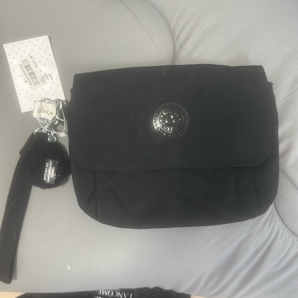 Kipling new with tags black medium purse with wrist strap.